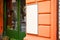 Signboard view of empty white mockup signage in frame with orange shop wall in background