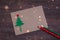 Signing handmade Christmas card with felt Christmas-tree, snowflakes effect and red star