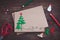 Signing handmade Christmas card with felt Christmas-tree, snowflakes effect and red star