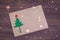 Signing handmade Christmas card with felt Christmas-tree, snowflakes effect and red star