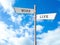 Signpost against beautiful sky. Concept of balance between work and life