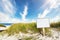 Signpost with copy space on wide sandy beach