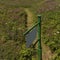 Signpost, footpath and field of wild flowers. England, UK