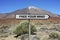 Signpost with FREE YOUR MIND text under volcano background