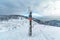 Signpost of Hiking trails in snowy winter Silesian Beskid mountains