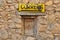 Signpost with little window in a stone wall