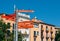 Signpost pointing to major landmarks in the historic city of Girona. Catalonian independence flag hanging from balconies