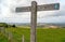 A signpost shows the route of the South Downs Way with views over the Weald