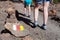 Signposted with Spanish flags colors hiking route to Lunar landscape Paisaje Lunar. Woman and child legs passing stone trail, Te