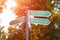 Signposts to the Old Town, Rotermann quarter and port in Tallinn, Estonia. Against the background of autumn foliage