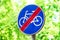 Signs for cyclists, road sign against a background of green trees