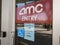 Signs on the door of an AMC movie theater stating a temporary closure due to COVID-19