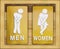 Signs female and male bathroom on wooden background.