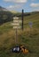 Signs with hiking routes and a wooden cross in the mountains of France region Haute-Savoie