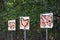 Signs with outlines of farm animals like cow, chicken and pig with multiple red target marks on th