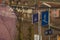 Signs for pedestrian underpass,a white pictogram on a blue board, next to a sign for a bus station outside