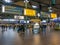 Signs and people at Schiphol Amsterdam Airport