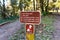 Signs posted at a trail junction offering trail information and warning that dogs are not allowed, Purisima Creek Redwoods