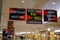 Signs for a storewide bankruptcy sale hanging from the ceiling in a nearly empty store with several customers