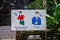 Signs telling visitors of the Ancient buddhist pagoda cave complex Bich Dong to wear long clothes and be polite