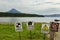 Signs warn of the danger of meeting tourists with bears on background of Kurile Lake and Ilyinsky volcano.