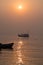 Sihouette of boat sailing in sunset in Mumbai beach at madh