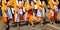 Sikh soldiers dressed in traditional orange clothes march barefo