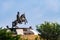 Sikh warrior bhai fateh singh statue sitting on the horse under blue sky background. historical concept