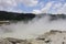 Sikidang crater with the background of sulfur vapor coming out of the sulfur marsh