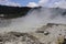 Sikidang crater with the background of sulfur vapor coming out of the sulfur marsh