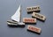 Silence your inner critic symbol. Wooden blocks with words Silence your inner critic. Beautiful grey background with boat.