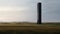 Silent Monuments: A Photorealistic Rendering Of A Black Tower In A Minimalist Scottish Landscape