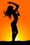 Silhouete of a fit woman hair flow hand over head