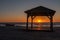 Silhouete of gazebo on the sea beach in beautiful sunset