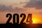 Silhouette 2024 with sunset sky at mountain and number like 2024 abstract background.