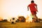 Silhouette action sport outdoors of diversity of kids having fun playing soccer football for exercise in community rural area unde