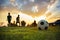 Silhouette action sport outdoors of a group of kids having fun playing soccer football for exercise in community under