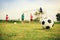 Silhouette action sport outdoors of a group of kids having fun playing soccer football for exercise in community under