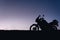 silhouette adventurous motorcycle on blue sunset sky, motorcycle touring background, adventure and travel concept, active