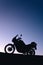 silhouette adventurous motorcycle on blue sunset sky, motorcycle touring background, adventure and travel concept, active