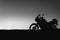 silhouette adventurous motorcycle on blue sunset sky, motorcycle touring background, adventure and travel concept, active