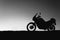 silhouette adventurous motorcycle on blue sunset sky, motorcycle touring background, adventure and travel concept, active