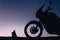 silhouette adventurous motorcycle on blue sunset sky with people, motorcyclists, motorcycle touring background, adventure and