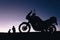 silhouette adventurous motorcycle on blue sunset sky with people, motorcyclists, motorcycle touring background, adventure and