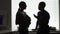 Silhouette of African American business colleagues talking