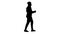 Silhouette African American businessman in glasses and tie dancing with his hands while walking.