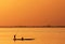 Silhouette of African fisherman in canoe