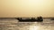 Silhouette of an African Fishing Boat with Fisherman Sailing in Ocean at Sunset