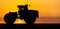 Silhouette of an agricultural tractor
