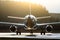 Silhouette of an aircraft illuminated by the sun contours contrast on a runway.